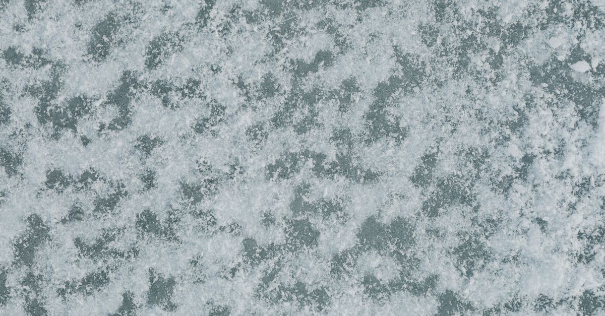 A detailed top view of snow covering the ground in winter, creating natural texture.